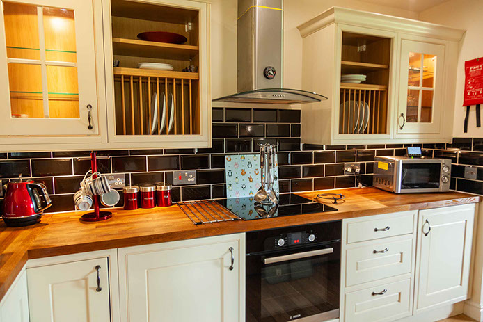 Culla Cottage Kitchen contains an oven Microwave Washing Machine Fridge Freezer Kettle and Toaster